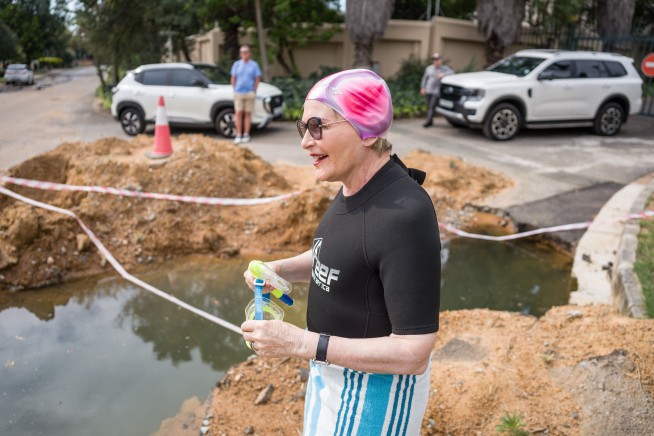 To Zing City, Mayoral Candidate Takes a Dip in a Giant Pothole
