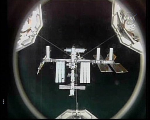 Shuttle Docks at Space Station