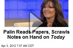 Palin Reads Papers, Scrawls Notes on Hand on Today