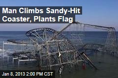 Man Climbs Sandy-Hit Coaster, Plants Flag