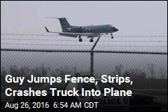Guy Jumps Fence, Strips, Crashes Truck Into Plane