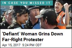 &#39;Defiant&#39; Woman Grins Down Far-Right Protester