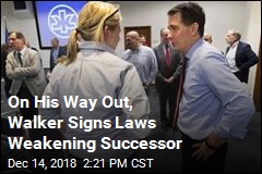 On His Way Out, Walker Signs Laws Weakening Successor