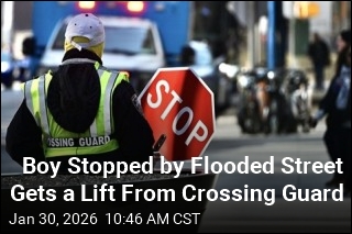 Boy Stopped by Flooded Street Gets a Lift From Crossing Guard