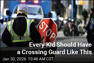 Boy Stopped by Flooded Street Gets a Lift From Crossing Guard